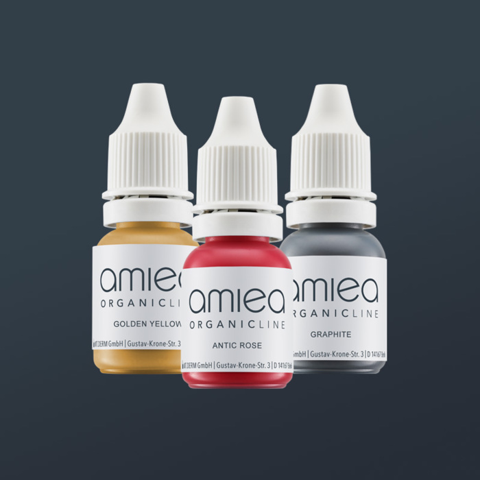 Three bottles of amiea organicline colors, on grey background