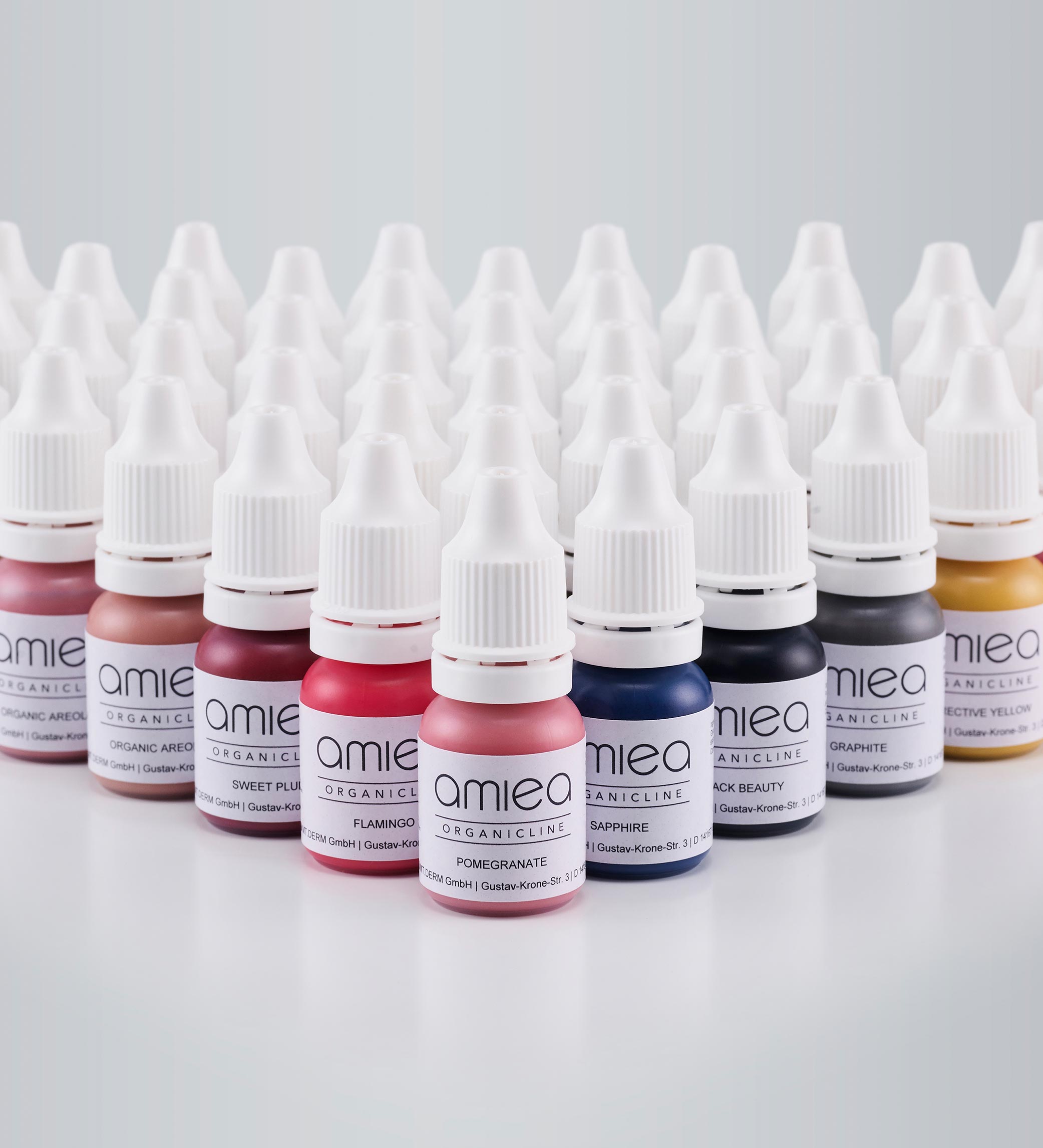 Bottles of amiea organicline colors on grey background