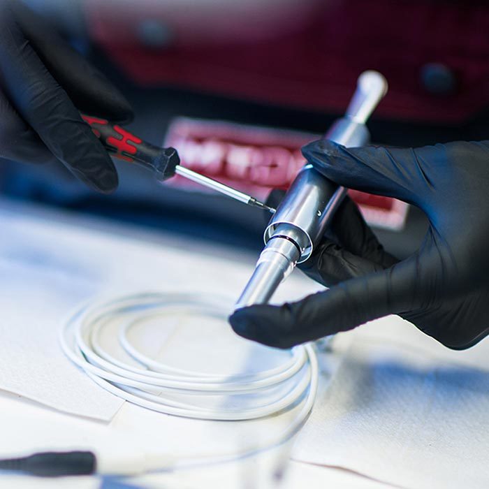 amiea quality testing  a picture of an amiea employee repairing an amiea device in amiea production center