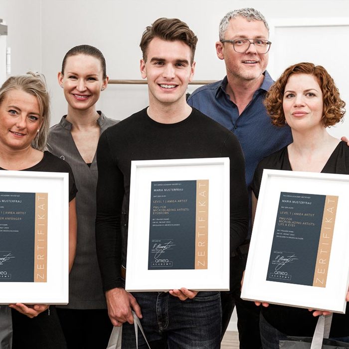 Group Photo with two Trainers and three students of amiea academy holding a amiea academy Certificate.