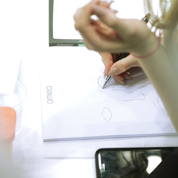 a picture of a woman sketching on an amiea sketchpad eyes 