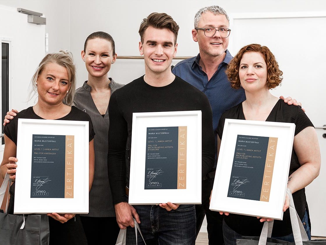 Group Photo with two Trainers and three students of amiea academy holding a amiea academy Certificate.