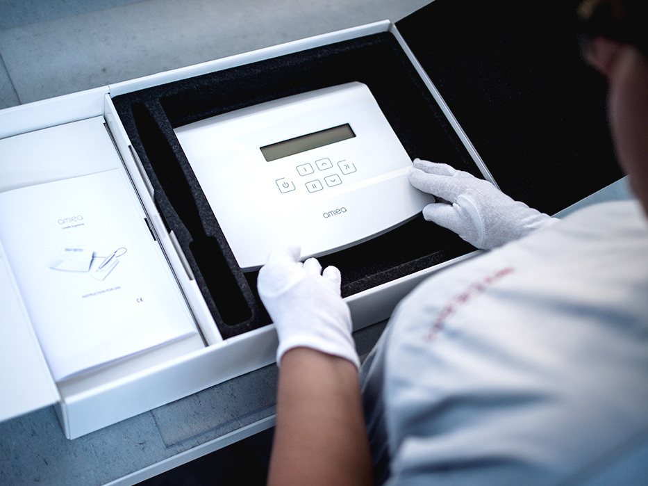 picture of a woman employee in the quality testing department of amiea production